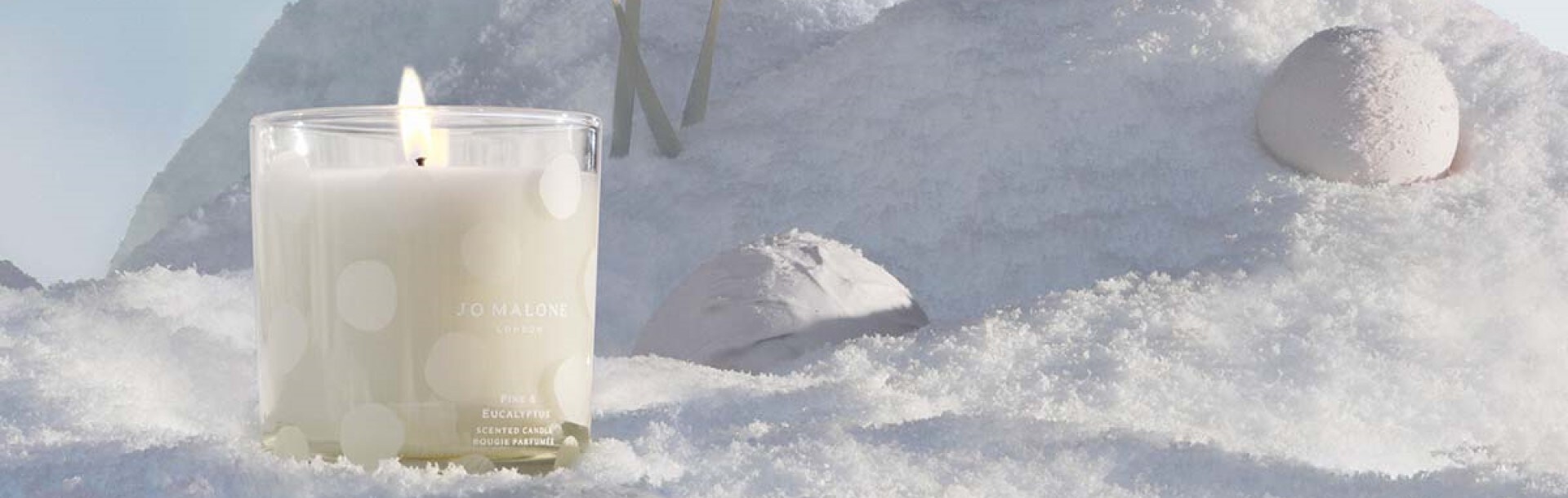 pine & eucalyptus home candle & diffuser, amongst snowballs and on a bed of snow. 